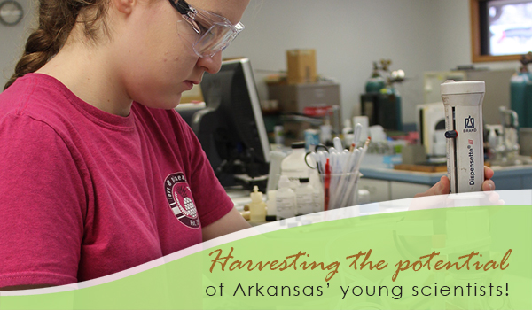 young student looking through a microscope